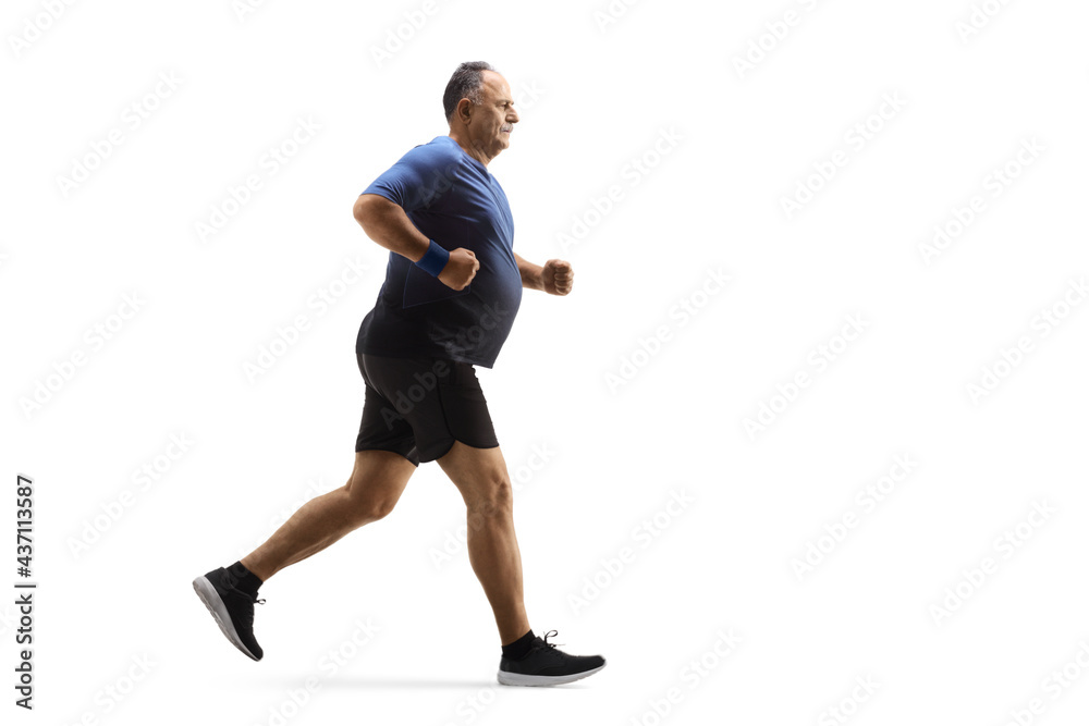 Full length profile shot of a corpulent mature man in sportswear running