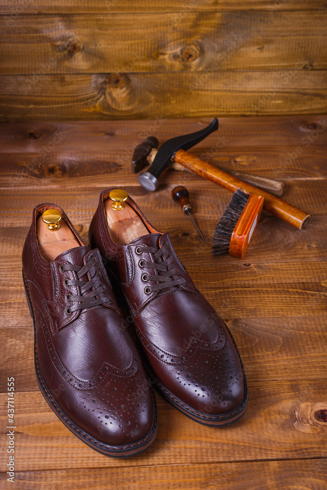 pair of shoes on a wooden background with instruments