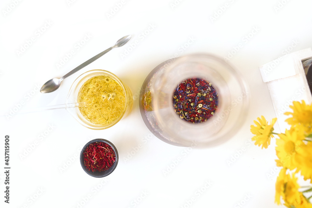 Flat lay with flowers and essential oils on a naturopath's worktable Flat lay with flowers and essential oils on a naturopath's worktable