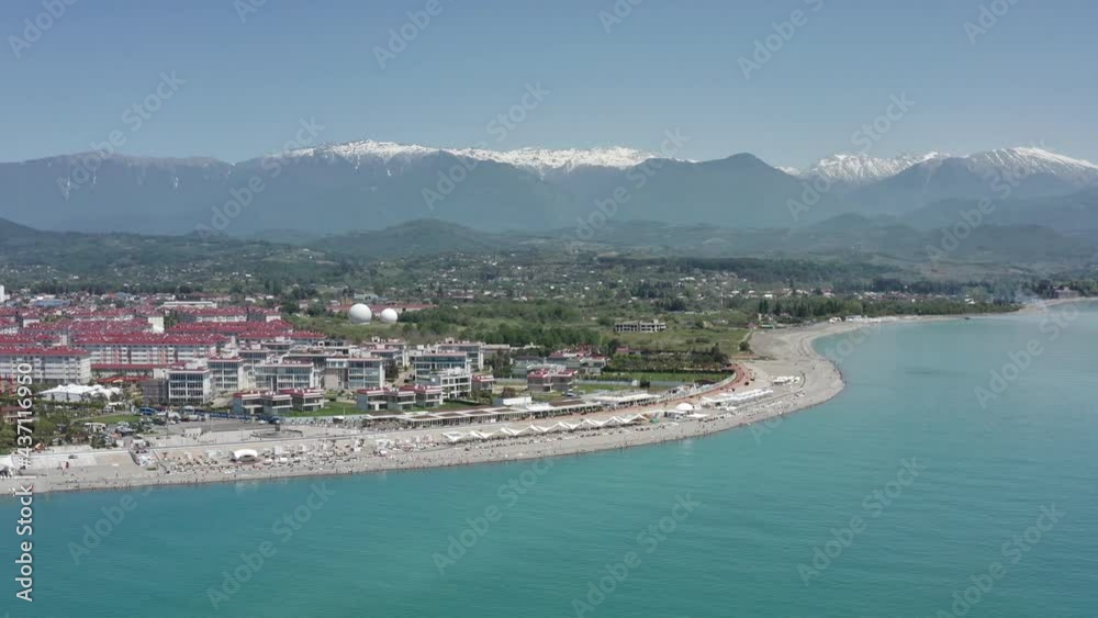 Aerial view resorts and beach. View on a wonderful beach of a resort in Sochi with crystal clear sea and people on vacation. Aerial view resorts and beach. View on a wonderful beach of a resort in Sochi with crystal clear sea and people on vacation.