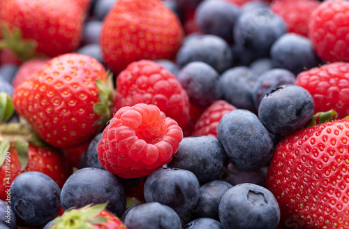 Raspberry, strawberry and blueberry berries in a basket