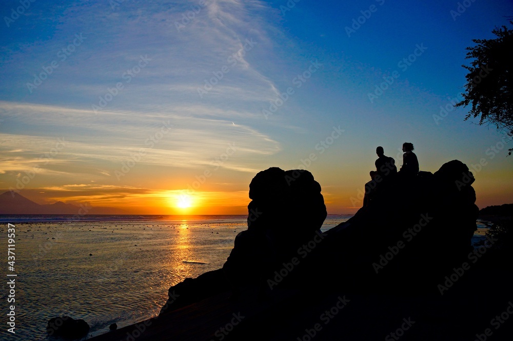 Couple watching the sunset at Gili Trawangan, Indonesia. 