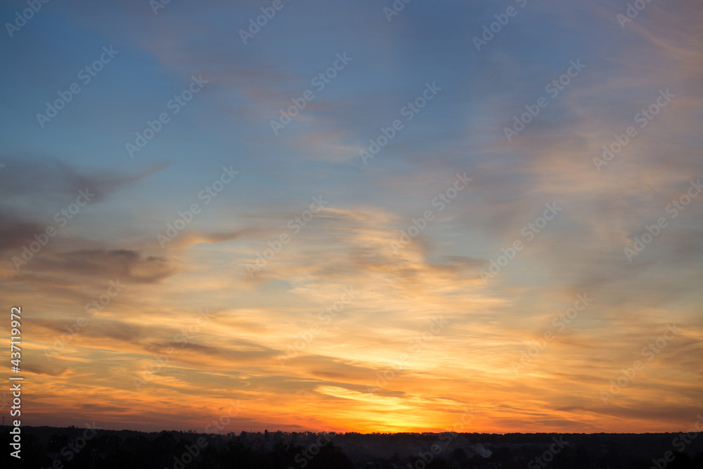 Colorful sunset sky with clouds in the evening