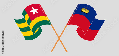 Crossed and waving flags of Togo and Liechtenstein