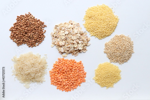 Top view of cereals of different types on white background.Buckwheat,oatmeal,rice,lentils,couscous,millet and quinoa