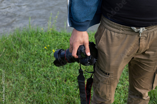 Close up, man photographer holding digital camera