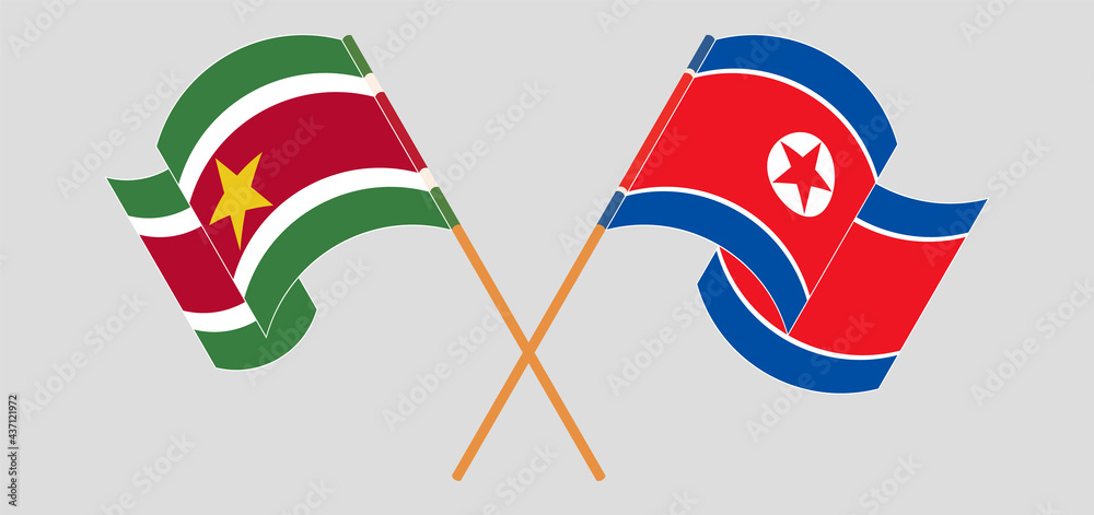 Crossed and waving flags of Suriname and North Korea Crossed and waving flags of Suriname and North Korea