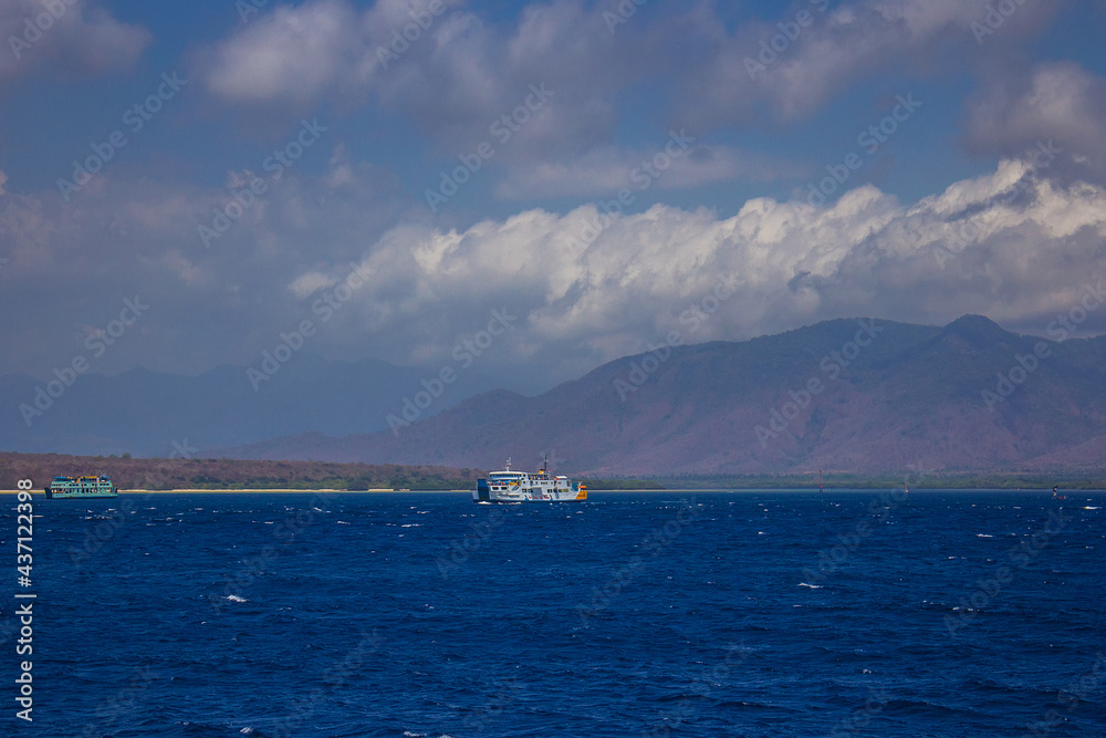 Ferries and boats sailing up and down the sea channel between Bali and Java islands, from Ketapang port to Gilimanuk port, Indonesia