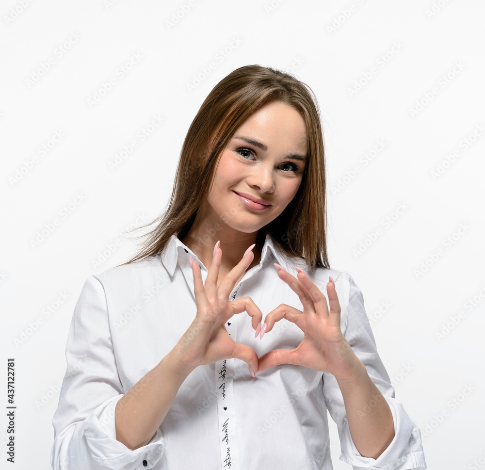 Smiling pretty woman making heart shape with her hands isolated on white Smiling pretty woman making heart shape with her hands isolated on white