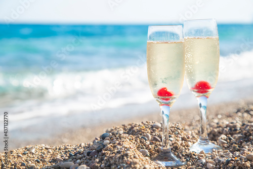 Glasses with champagne on the sea. Copy space