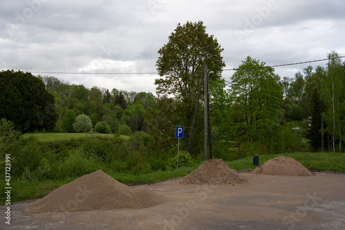 car parking place where large piles of sand are thrown photo