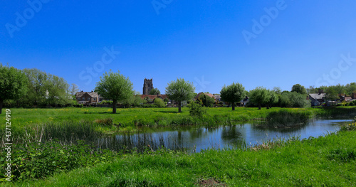 a serene landscape of a river running through a peaceful Suffolk water meadow photo