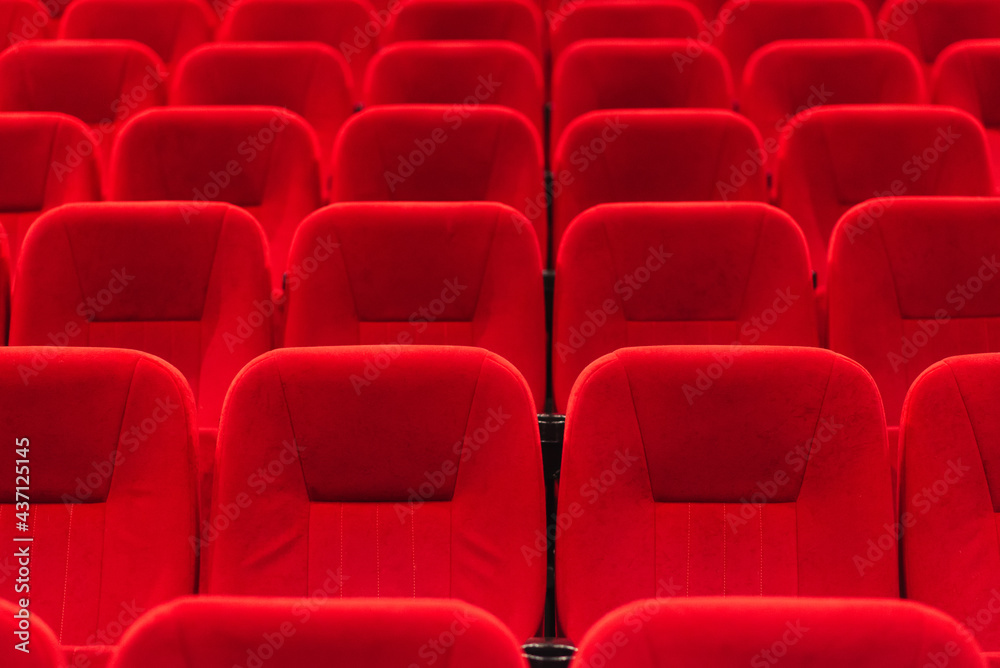 Naklejka premium An empty cinema room with red velvet seats. Empty cinema.