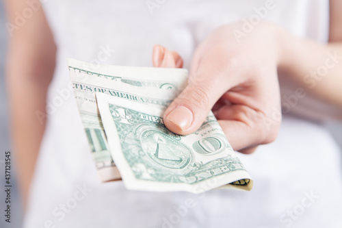 young woman gives money