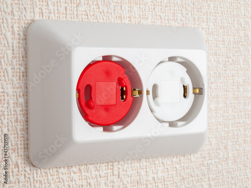 protection of sockets from children, electric shock protection plug, close-up, safe house, small children photo