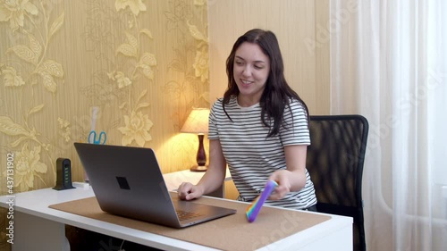 Woman has video call conversation and shows pop it toy