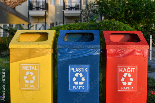 Yellow blue and red dustbins for separate waste management, circular economy concept. 