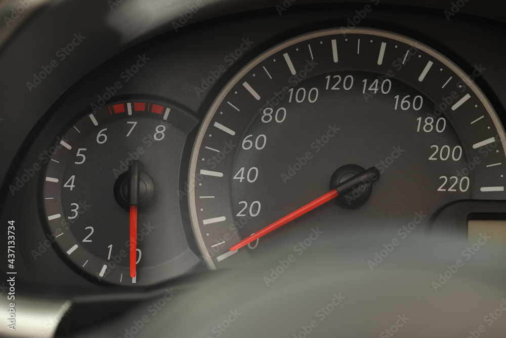 Speedometer and tachometer on modern car dashboard