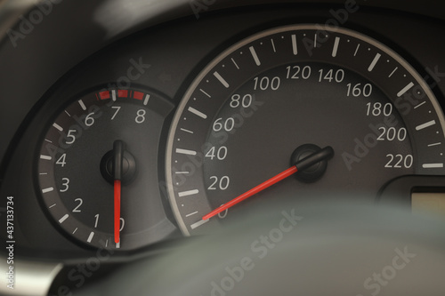 Speedometer and tachometer on modern car dashboard