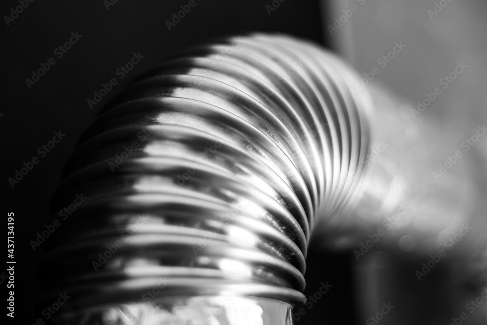 Close-up of steel pipe with round corner on black background. Black and white photo. Close-up of steel pipe with round corner on black background. Black and white photo.