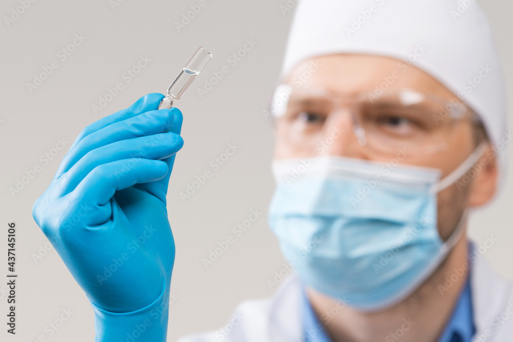 Doctor holding a viol with vaccine against corona virus. Doctor holding a viol with vaccine against corona virus.