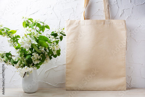 Rustic tote bag mockup with  flowering apple tree branch photo