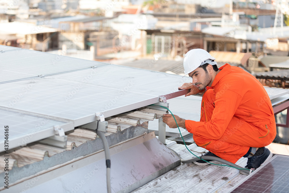 engineer or technician checking and fixing solar panels on the top of the roof engineer or technician checking and fixing solar panels on the top of the roof