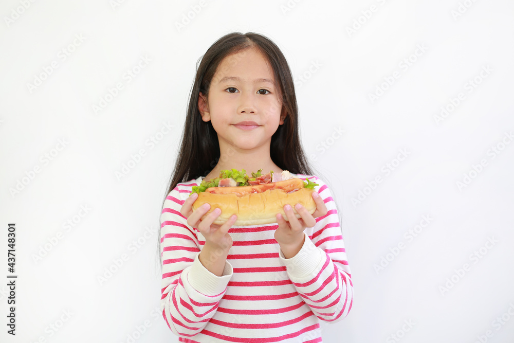 Portrait of Asian little child girl holding HOT DOG for you on white background. Focus at kid face Portrait of Asian little child girl holding HOT DOG for you on white background. Focus at kid face
