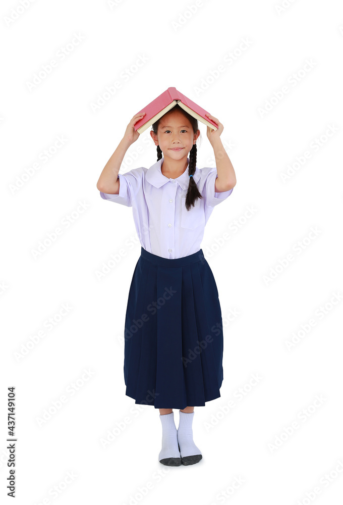 Asian little girl child in Thai school uniform standing with hold open book cover over head isolated on white background. Full length with clipping path Asian little girl child in Thai school uniform standing with hold open book cover over head isolated on white background. Full length with clipping path