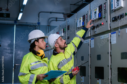 Engineer checking and inspecting at MDB panel , working with electric switchboard to check  medium Voltage Switchgear working in Main Distribution Boards factory.