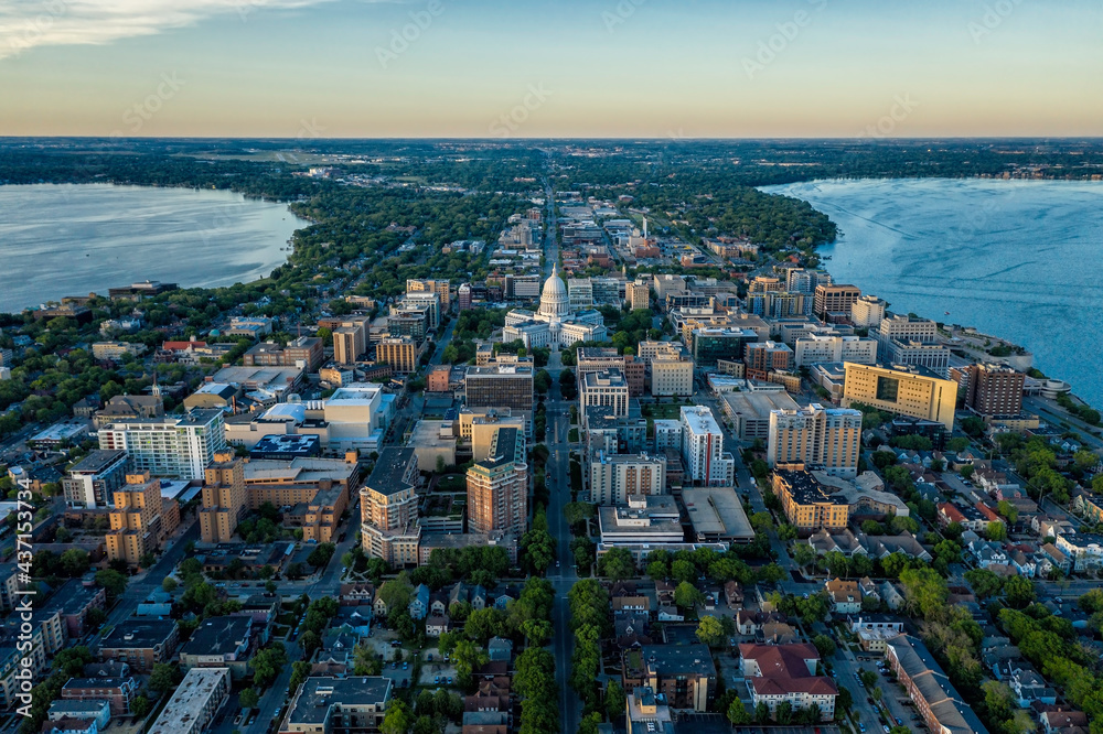 Aerial view of Madison city downtown, urban grid with capitol building between two lakes, sunset light