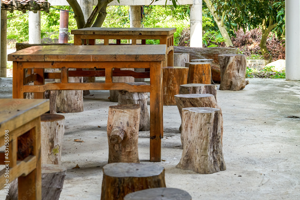 The arrangement of wooden tables and stools in the rural farmhouse