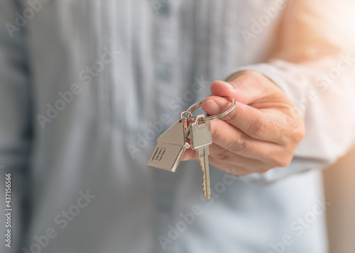 House key in landlord, real estate sale person or home Insurance broker agent hand giving to tenant, renter, buyer customer for new family owner, property assurance concept