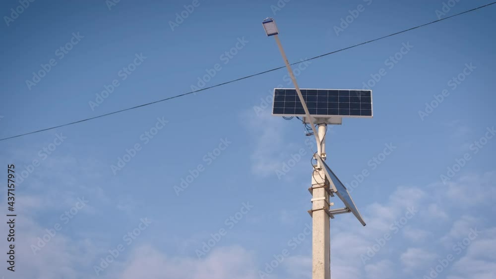 Modern lamp against the sky. Solar powered lantern. A street lamp against blue light sky in the day light. Modern lamp against the sky. Solar powered lantern. A street lamp against blue light sky in the day light.