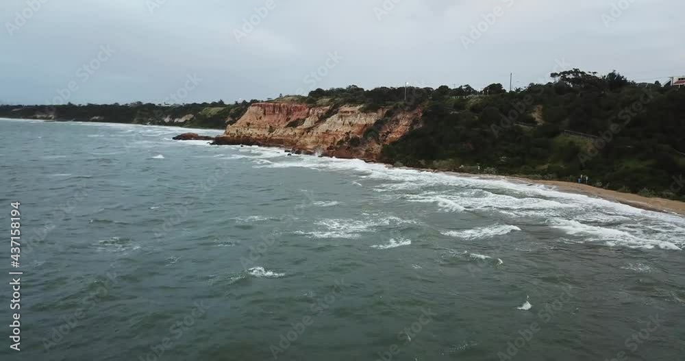 Drone aerial over ocean Melbourne wavy windy cloudy cliff side Drone aerial over ocean Melbourne wavy windy cloudy cliff side