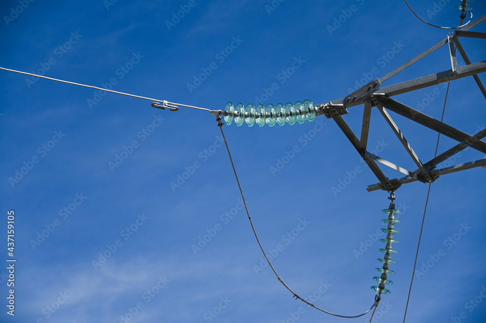 Part of a high voltage power tower with glass insulators close-up ...