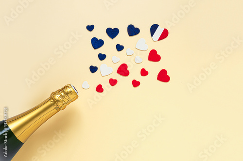 Hearts in the colors of the French flag and French champagne bottle, top view, Bastille Day and French National Day concept photo