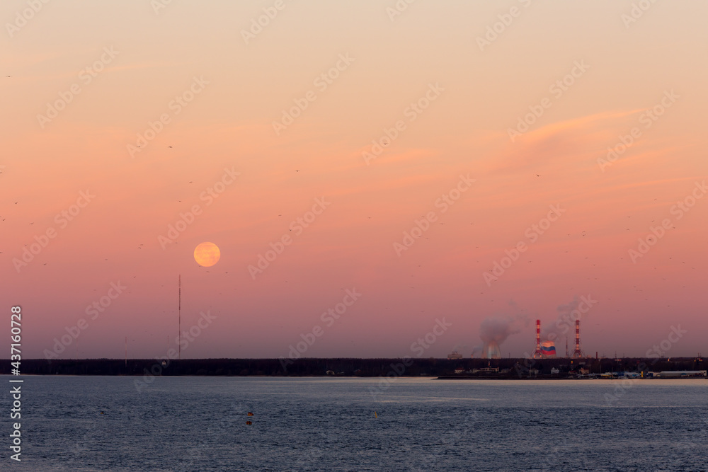 sunrise over the bay with the moon