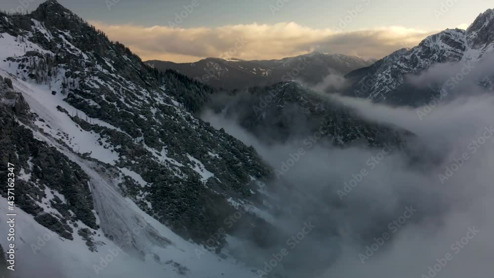 Rolling clouds over white snowy mountains. Sunset hyperlapse