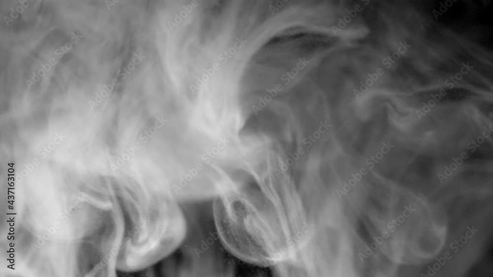 Abstract Smoke Floating Through Space Against Black Background - studio shot Abstract Smoke Floating Through Space Against Black Background - studio shot