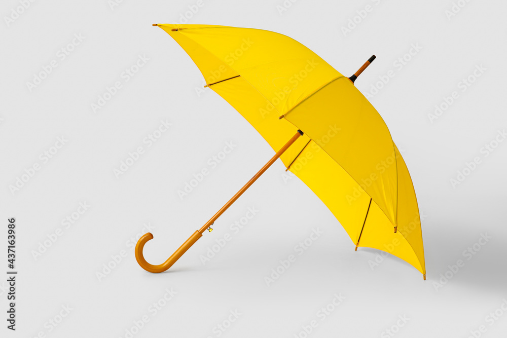 Stylish yellow umbrella on light background - obrazy, fototapety, plakaty 