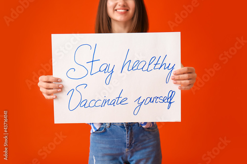 Young woman holding poster ...