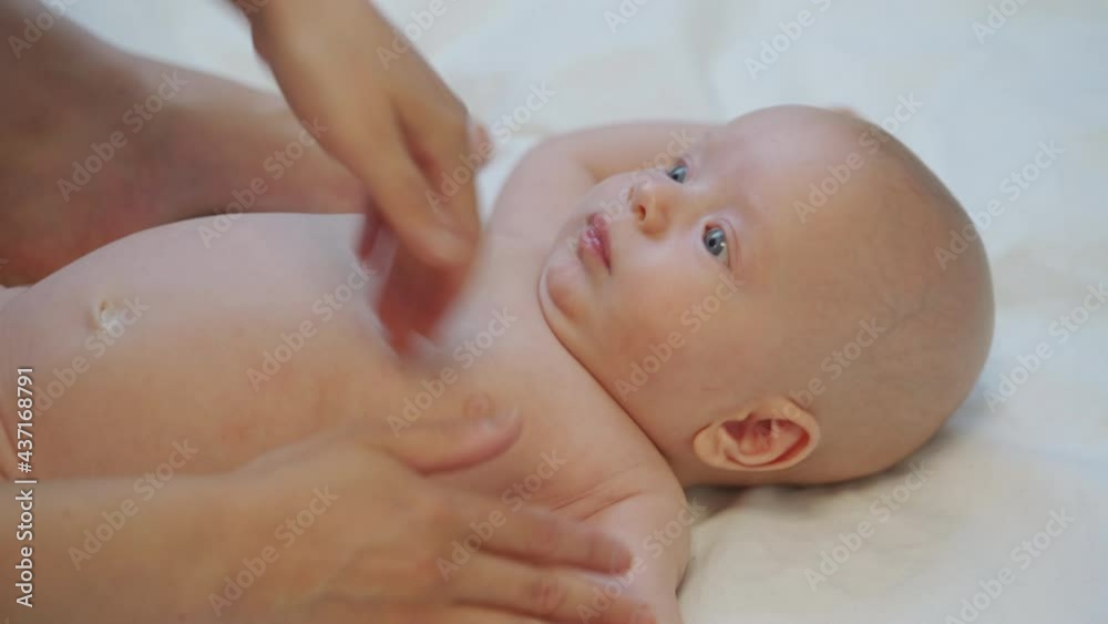 Mother massage 3 months old baby boy gently ppressing, rubbing parts of infant body, relax baby. High quality 4k footage Mother massage 3 months old baby boy gently ppressing, rubbing parts of infant body, relax baby. High quality 4k footage