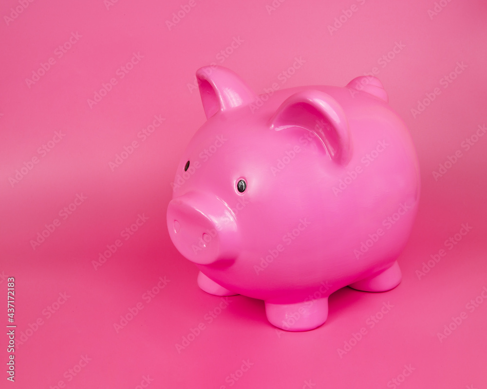 Pink piggy bank ceramic money toy with copy space on pink background