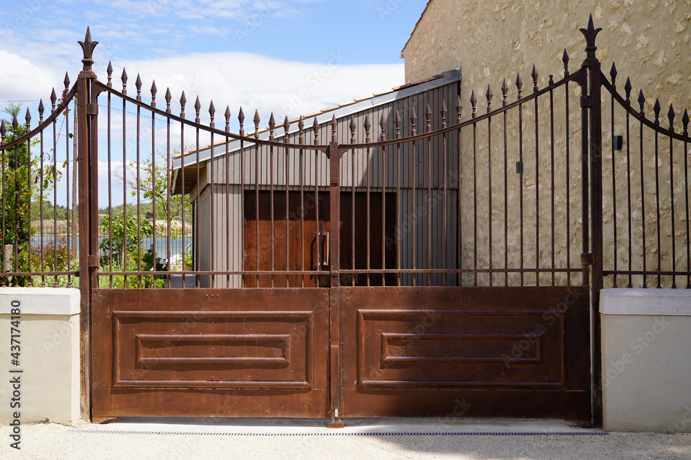 large high portal rusty brown metal vintage house retro classical steel gate in europe