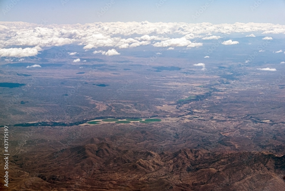 Aerial view over Rincon Mountains to irrigated fields and river valley near Benson, Arizona