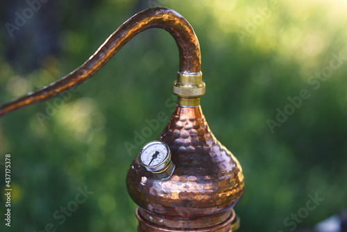 Konstfotografi Top detail of antique copper alembic with temperature thermometer