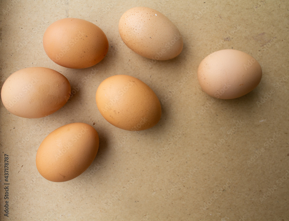 the eggs lie loosely on the brown table. the eggs lie loosely on the brown table.