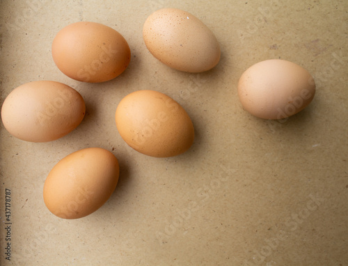 the eggs lie loosely on the brown table.