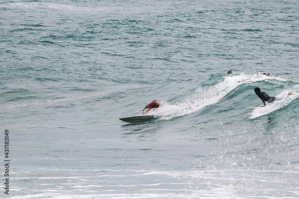 Fototapeta premium Surfer on Blue Ocean Wave . Surf spot in Ericeira Portugal.